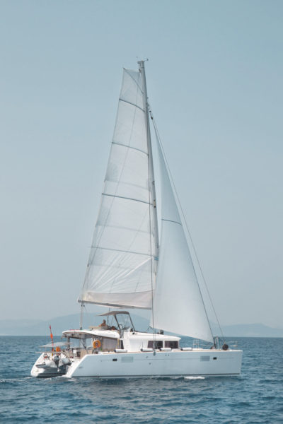 A sail boat is sailing on the ocean.