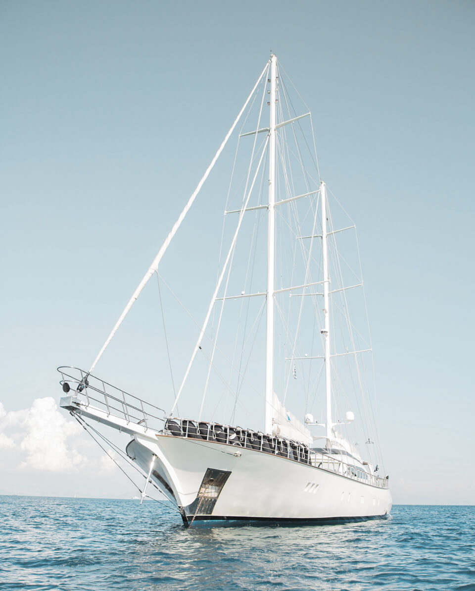 A white boat floating on top of the ocean.
