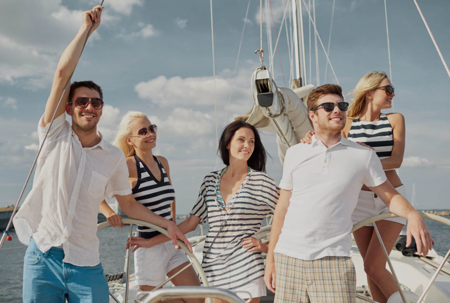 A group of people standing on top of a boat.