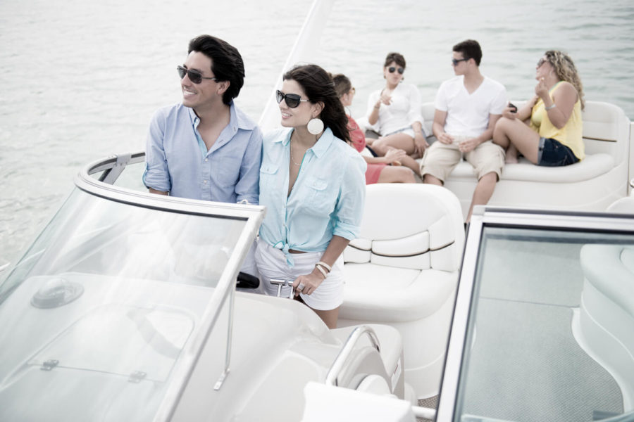 A group of people on a boat in the water.