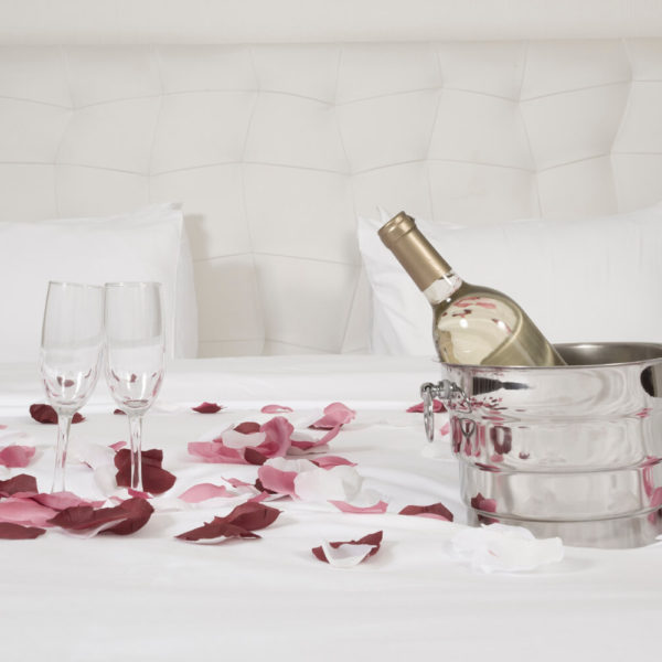 A bottle of wine and two glasses on the table.