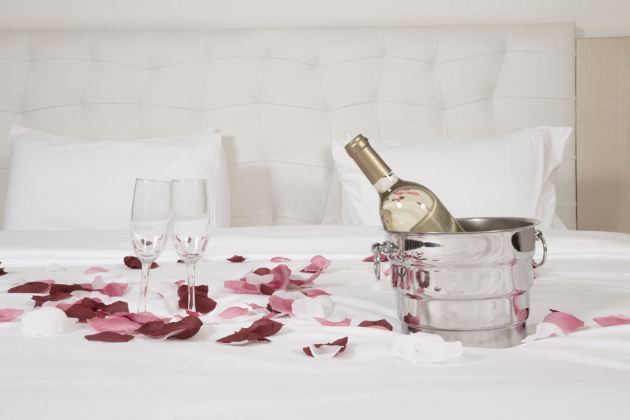 A bottle of wine and two glasses on the table.
