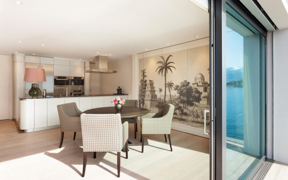 A dining room with a view of the ocean.