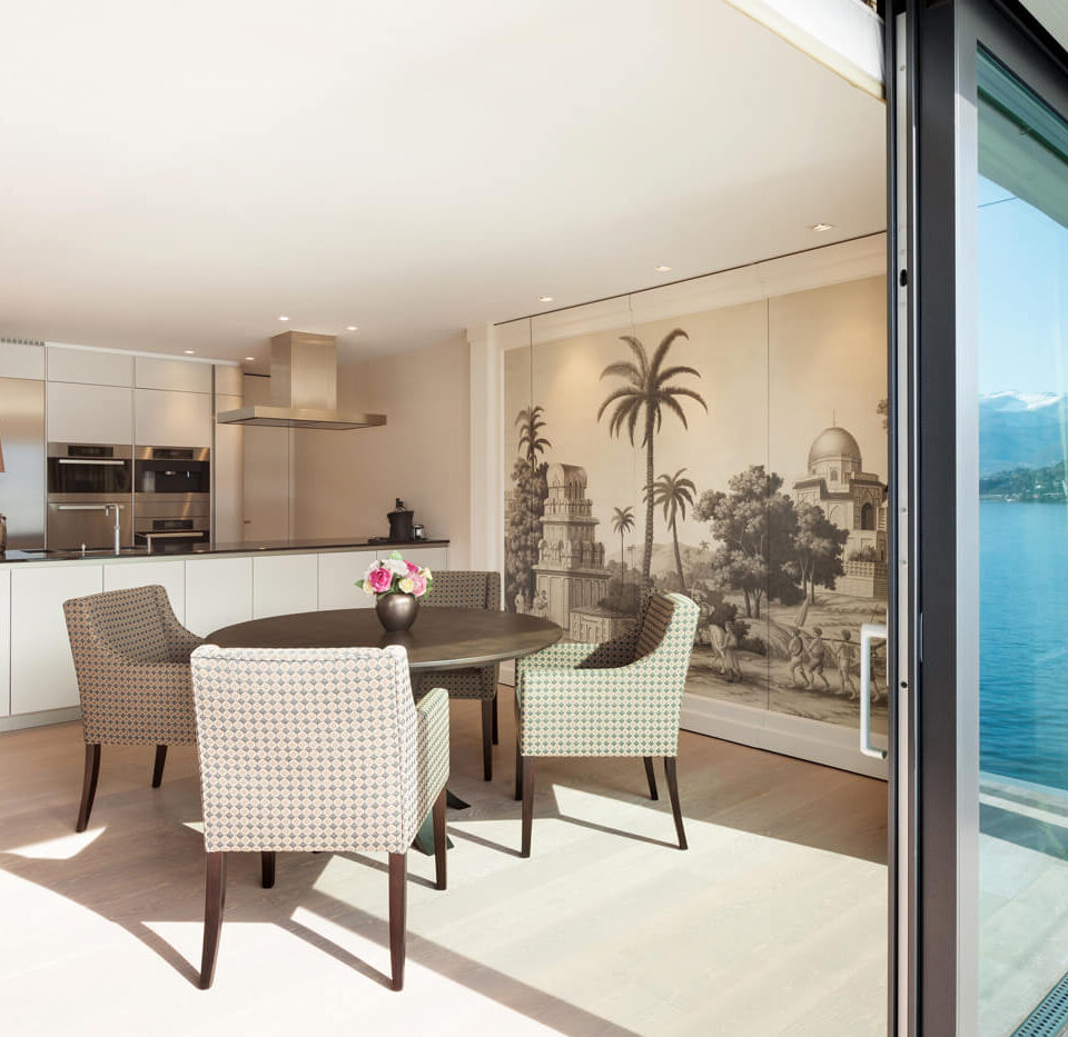 A dining room with a view of the ocean.